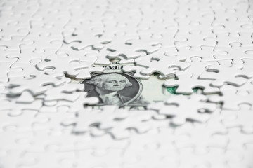 Missing jigsaw puzzle pieces on money dollar background, Business solution concept ,key for success