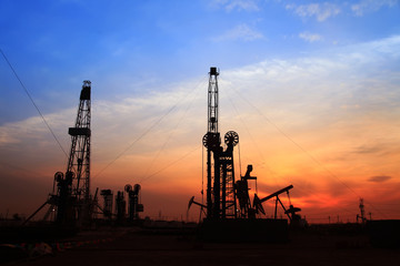 the silhouette of oilfield derrick