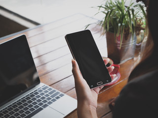 hand using smartphone in coffee shop cafe