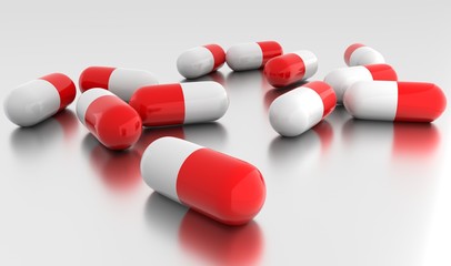 Medication capsules on metallic surface  