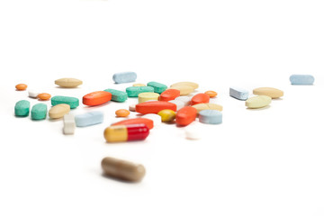 Piles of pills and capsule isolated white background. Selective focus