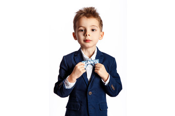 Portrait of a boy in a classic suit with a bow tie.