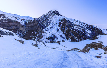 Fototapeta na wymiar Snow-covered road in the mountains