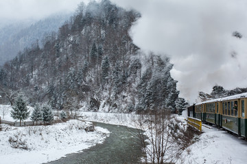 train in winter near a river