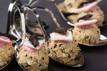 delicious salad, cold appetizer is laid out on curly spoons