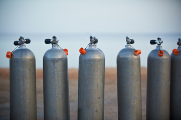 Collection of grey scuba diving air oxygen tanks.