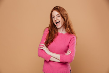 Portrait of a young joyful redhead girl looking at camera