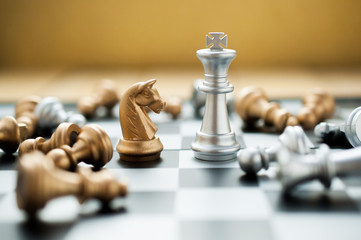 Silver King chess versus horse and failed pawn on chess board game.business strategy concept.