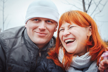 Couple man in white hat and woman with red hair outdoors