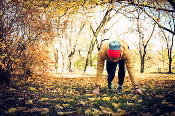 Fototapeta premium Young man start run . Autumn season.