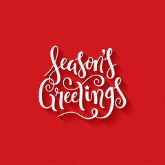 SEASON’S GREETINGS brush calligraphy on red giftwrap background © HowLettery Studio