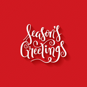 SEASON’S GREETINGS brush calligraphy on red giftwrap background