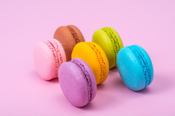 Small French macaroons on pastel background