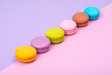Small French macaroons on pastel background