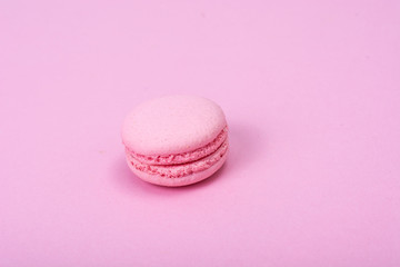 Small French macaroons on pastel background