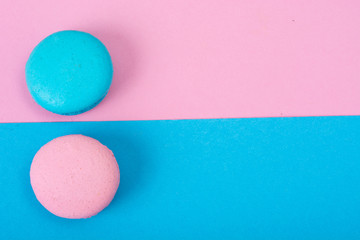 Small French macaroons on pastel background