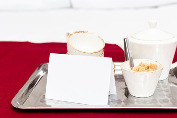 Two white mugs on a tray white bed, breakfast concept