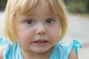 Adorable little girl making disgusted or surprised face