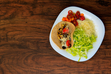 Top view on a plate with tasty taco with grilled vegetables