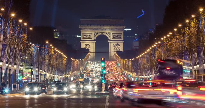 Christmas in Paris. Timelapse of avenue des Champs-Elysees with Christmas lighting leading up to the Arc de Triomphe in Paris, France. Zoom in effect.