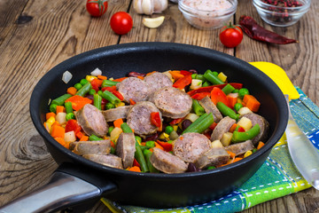 Vegetable dish with pieces of sausage for dinner