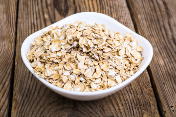 Oat flakes in white bowl for cooking