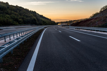 Empty Highway with markings at sunset