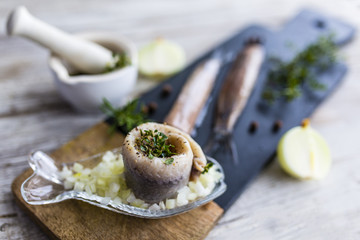 Delicious wrapped herring with fresh herbs and onions.