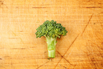 Fresh green broccoli on a wooden board and dark table