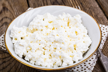 Fresh homemade cottage cheese in white bowl