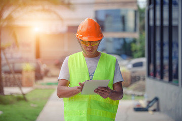 Fototapeta premium Asian engineer checking solar panel setup with tablet