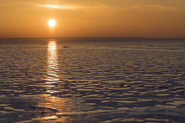 Winter nature landscape. Sunset over the frozen Ob sea.