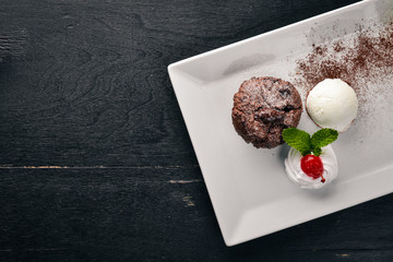 Chocolate ice cream cake. On a wooden background. Free space for your text. Top view.