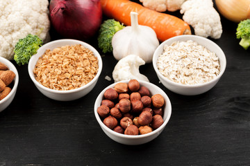 Fresh raw vegetables with nuts and cereals for cooking or eating. Vegetarian food. Top view