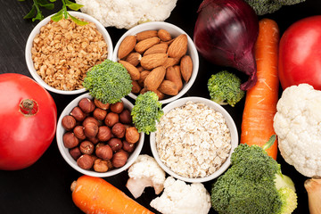 Fresh raw vegetables with nuts and cereals for cooking or eating. Vegetarian food. Top view