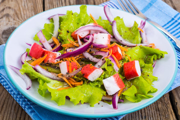 Delicious vegetable salad with crab sticks