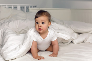 boy baby t-shirt lies under a blanket