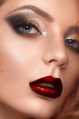 Naklejka premium Beautiful redhair model: curls, bright makeup, jewelry and red lips. The beauty face.