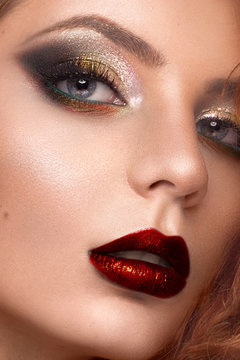 Beautiful redhair model: curls, bright makeup, jewelry and red lips. The beauty face.