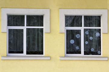 Detail image of a yellow building with windows