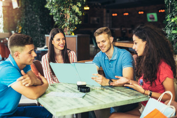 Group of young people meeting in a cafe, having fun.