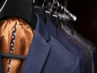Mens suits on hangers in different colors