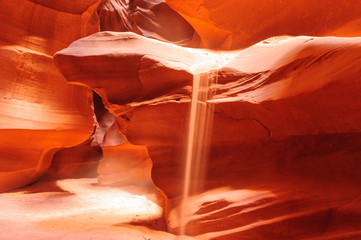 Sand Flowing off the Red Rocks of Antelope Canyon