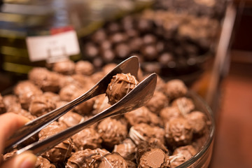 Belgium tasty truffle delicious chocolate in a row, candy shop view. Food travel tourism.