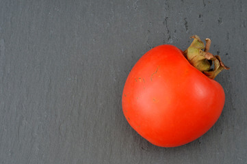 persimmon on slate plate, flat