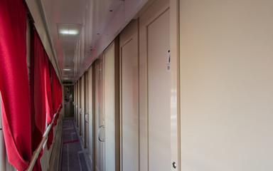 Train interior, long corridor and many doors
