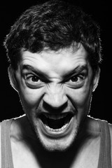 Angry young man shouting.