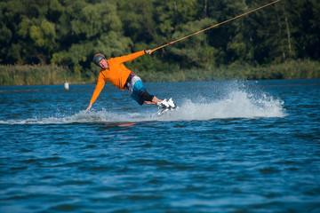 Concentrated man making a wakeboarding trick