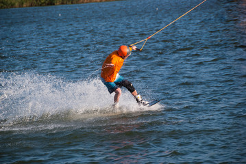 Concentrated man trains on a wakeboard