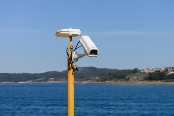 security camera on blue sky background